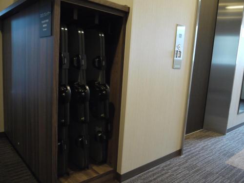 a wine rack in a elevator in a building at Ueda Ekimae Royal Hotel in Ueda