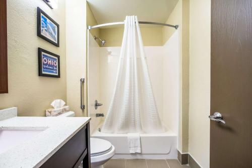 a bathroom with a shower with a toilet and a sink at Comfort Inn & Suites Fairborn near Wright Patterson AFB in Fairborn