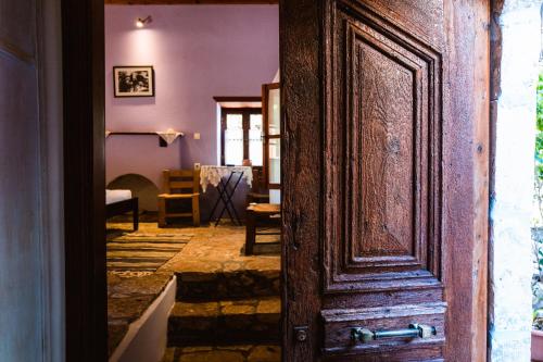 an open wooden door in a room with a table at Karnayo in Meyisti