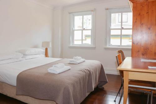 a bedroom with a bed with two towels on it at Glasgow Arms Hotel Ultimo in Sydney