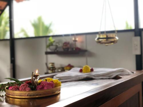 a kitchen counter with a bowl of food on a table at The Ayur Villa in Kovalam