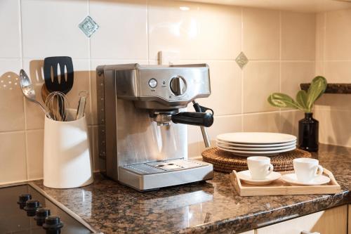 a coffee maker on a counter in a kitchen at Sea Change Beachfront Apartments in Trinity Beach