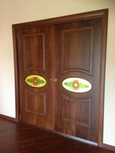 two wooden doors with two plates on them at Magnolia House in Taurianova