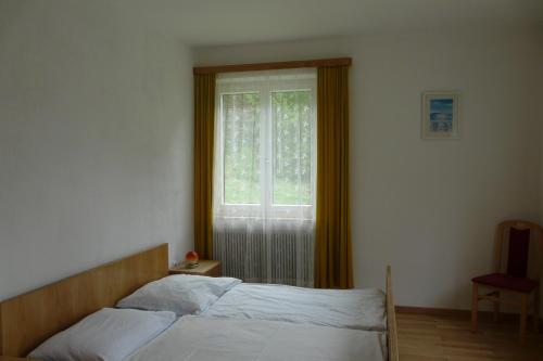 a bedroom with a bed and a window at Waldcamp Frank in Wildalpen