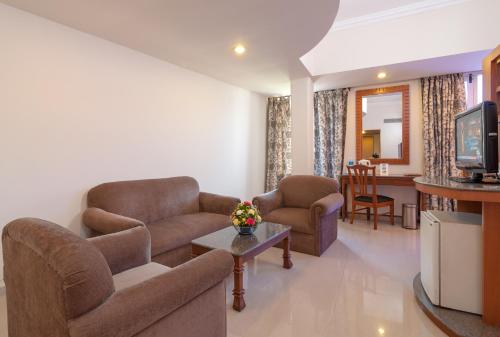 a living room with two couches and a television at Nanutel Margao in Madgaon