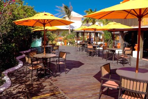 an outdoor patio with tables and chairs with umbrellas at Pancala Vacation Inn in Nanwan