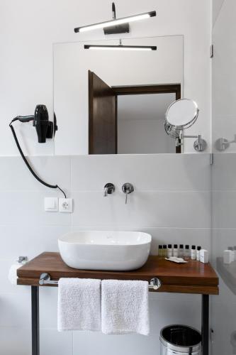 a bathroom with a sink and a mirror at Hotel Posta in Mestia