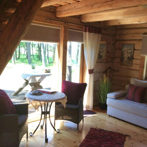 a living room with a couch and a table at Ungru Holiday Houses in Suuresadama