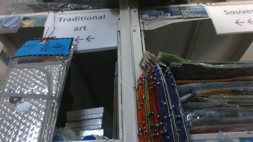 a group of different colored pens on a shelf at Paros Carmel studio-apartment in Logaras