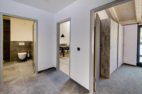 an open hallway with a bathroom with a toilet at Brandlhof lodge in Saalfelden am Steinernen Meer