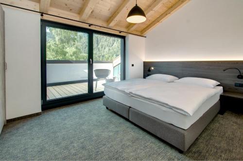 Postel nebo postele na pokoji v ubytování Brandlhof lodge