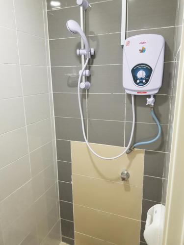 a shower with a hand dryer in a bathroom at Hotel Double Stars Cameron Highlands in Cameron Highlands