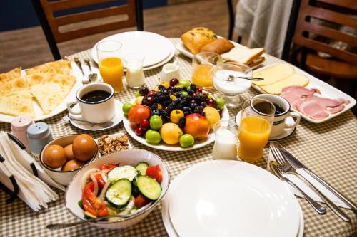 a table with plates of food and fruit on it at Mariam R in Tbilisi City