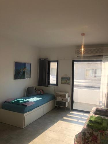 a bedroom with a bed and a window at AgiaNapaNest studio in Ayia Napa