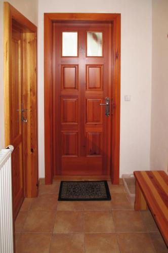 a wooden door in a room with a tile floor at Apartman 300 in Janske Lazne