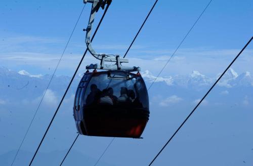 a ski lift in the sky with people on it at Chandragiri Hills Resort Kathmandu-Luxury in the Clouds in Thānkot