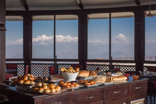 a table with many different types of bread and pastries at Chandragiri Hills Resort Kathmandu-Luxury in the Clouds in Thānkot