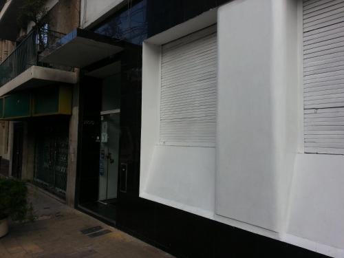 a white building with a roll up garage door at Hotel Isis in Buenos Aires