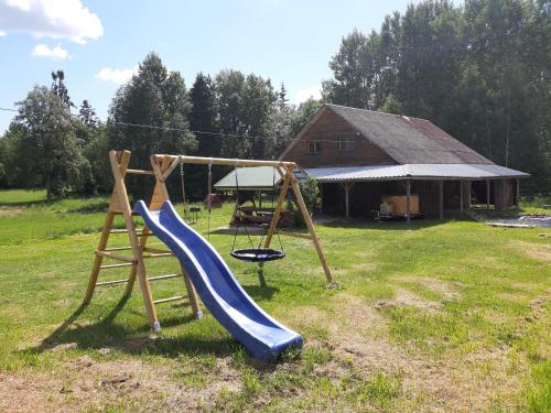 a playground with a slide and a swing at Huntingbox in Purila