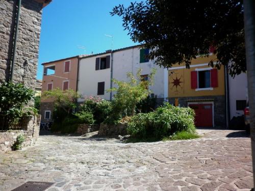 a building with colorful shutters on a street at Maisonette Tommy in Capraia