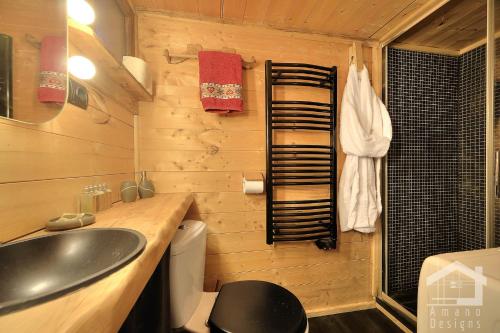 a bathroom with a sink and a toilet at Le Mazot de la Fis in Chamonix