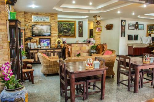 a living room filled with tables and chairs at Iyara Hua Hin Lodge in Hua Hin