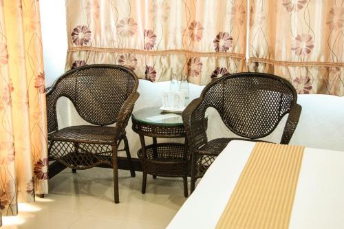 a room with two chairs and a table and a bed at Iyara Hua Hin Lodge in Hua Hin