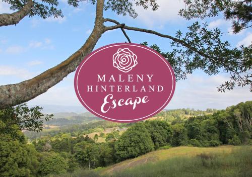a sign hanging from a tree with a valley interpreter and preserve at Maleny Hinterland Escape in Witta