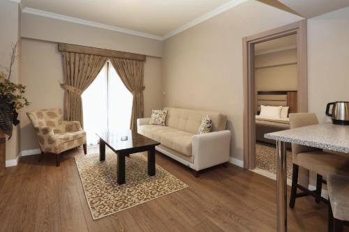 a living room with a couch and a table at New Balturk Hotel Izmit in Kocaeli