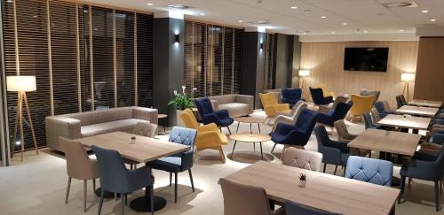 a dining room with tables and chairs and tablesktop at Blue Marine Mielno in Mielno