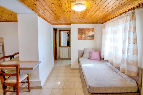 a living room with a couch and a table at PanDora Apartments in Moúdhros