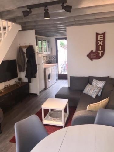 sala de estar con sofá y mesa en Maison à l'Amélie Plage, 300 mètres de la plage/mer, en Soulac-sur-Mer