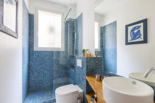 a bathroom with a toilet and a tub and a sink at Veeve - Eiffel Elegance in Paris