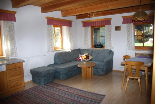 a living room with a couch and a table at Bauernhof Hatzlhof in Schöder