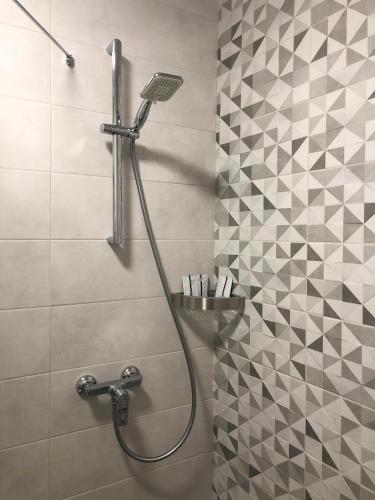 a bathroom with a shower with a shower head at East Residence in Kyiv