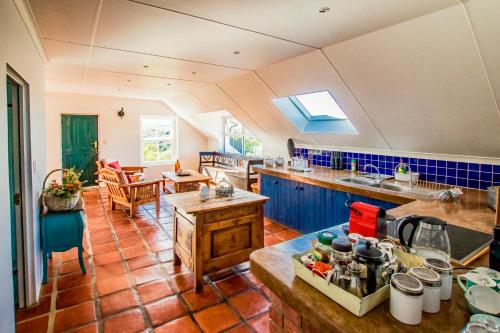 a kitchen with a table and a counter top at Oudewerfskloof Olive Farm in Stilbaai