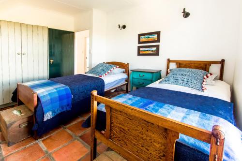a bedroom with two beds in a room at Oudewerfskloof Olive Farm in Stilbaai