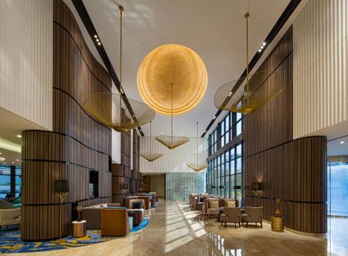 a lobby with couches and chairs in a building at Millennium Place Dubai Marina in Dubai
