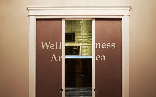 a glass door with the wordswell interest art at LE RÊVE DE NAIM Roma in Rome