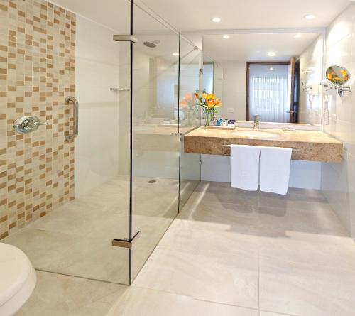 a bathroom with a glass shower and a toilet at Hotel Estelar Calle 100 in Bogotá