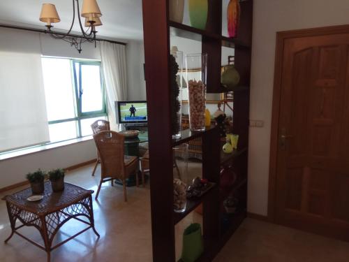 a living room with a table and a dining room at Apartamento A Peregrina (Silgar, Sanxenxo) in Sanxenxo