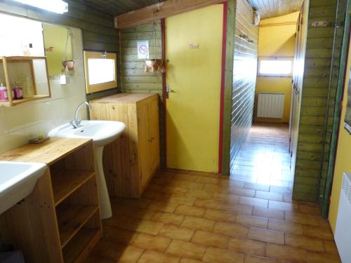a bathroom with a sink and a shower with a mirror at Gite d'Etape et de Sejour de Meolans in Méolans