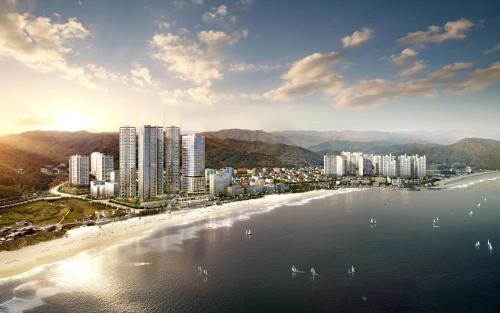 an aerial view of a city with a beach and buildings at Mercure Ambassador Ulsan in Ulsan