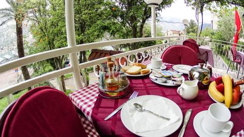 a table with plates of food on a balcony at Hotel Bokeljski Dvori in Kotor