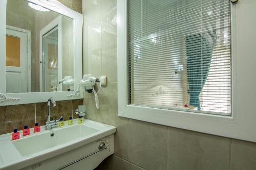a bathroom with a sink and a mirror at Hotel Karbel Sun in Oludeniz