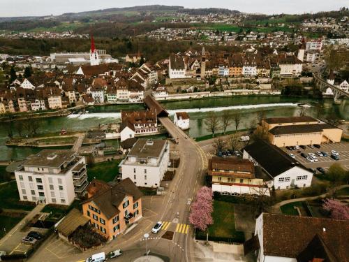 an aerial view of a city with a river and buildings at Hotel - Restaurant Waage in Bremgarten