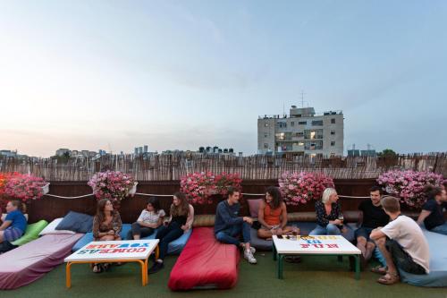 a group of people sitting on couches on a rooftop at Abraham Jerusalem in Jerusalem