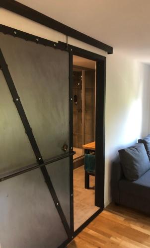 a sliding barn door in a living room with a couch at Fenix Hall Boutique Hotel Hallstatt in Hallstatt