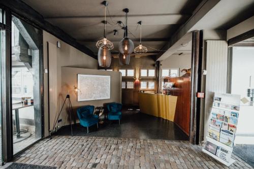 a room with two blue chairs and a table at Magni Boutique Hotel in Braunschweig