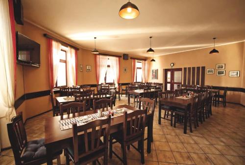 a restaurant with tables and chairs in a room at Restaurace a Penzion Praha in Dolní Dunajovice